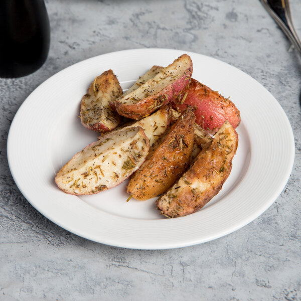 A CAC Harmony white porcelain plate with food and a fork.