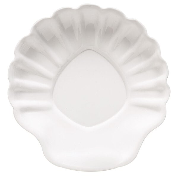 A white table plate with a scallop shell pattern.