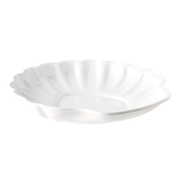 A white plate with a scalloped edge.