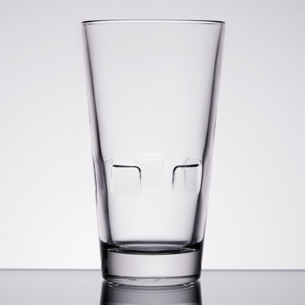 A close-up of a Libbey stackable beverage glass with ice cubes.