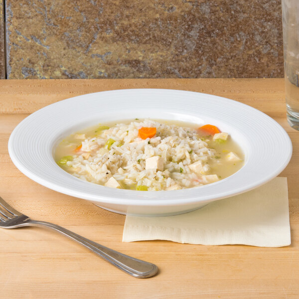 A CAC super white porcelain soup bowl with rice and vegetables.