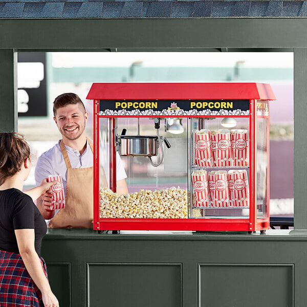 concession stand man handing popcorn to customer