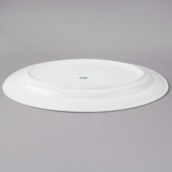 A CAC Super White porcelain platter on a gray surface.