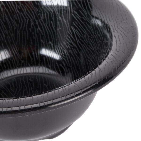 A close up of a black GET Etchedware melamine bowl with a textured crack.