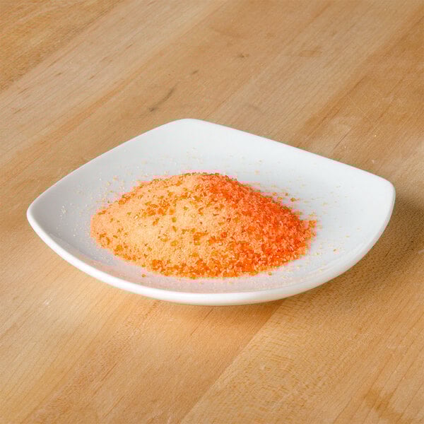 A white plate with Rokz mango cocktail rimming sugar on it.