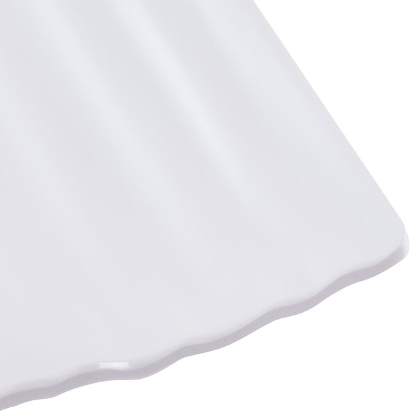 A close up of a white Polynesian square plate with a curved edge.