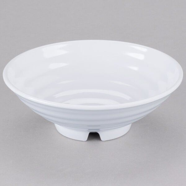 A white GET Milano melamine bowl with a spiral design on a gray surface.