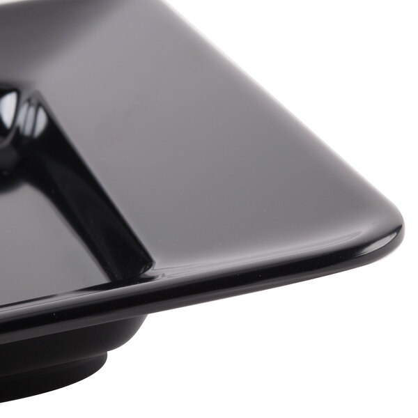 A close up of a black rectangular Milano plate.