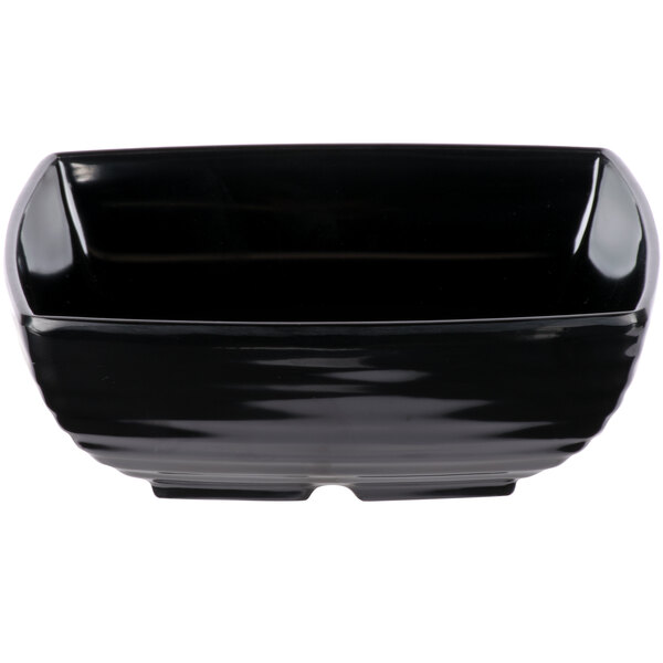 A black square melamine bowl with a curved edge.