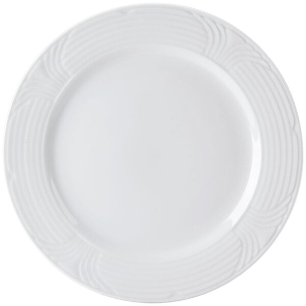A close-up of a CAC Corona white porcelain plate with an embossed design.