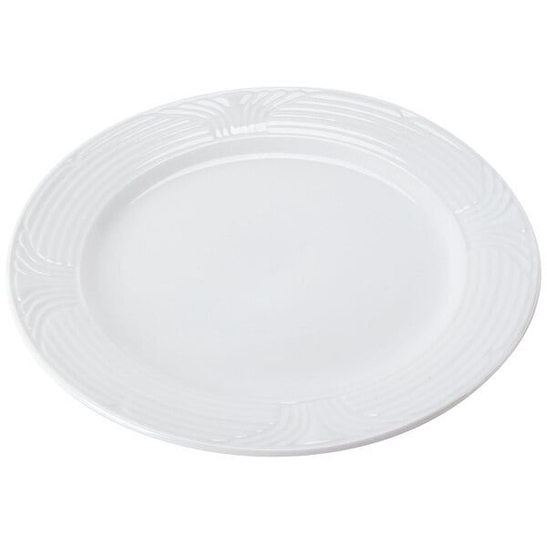 A CAC Corona white porcelain plate with a swirl design.