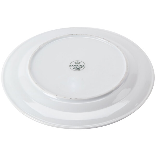 A CAC Corona white porcelain plate with an embossed design.
