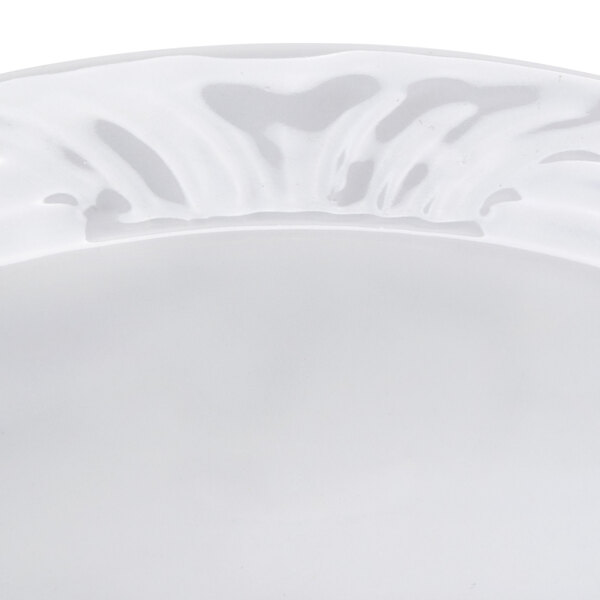 A close-up of a CAC CRO-11 Corona white porcelain fruit bowl with an embossed design.