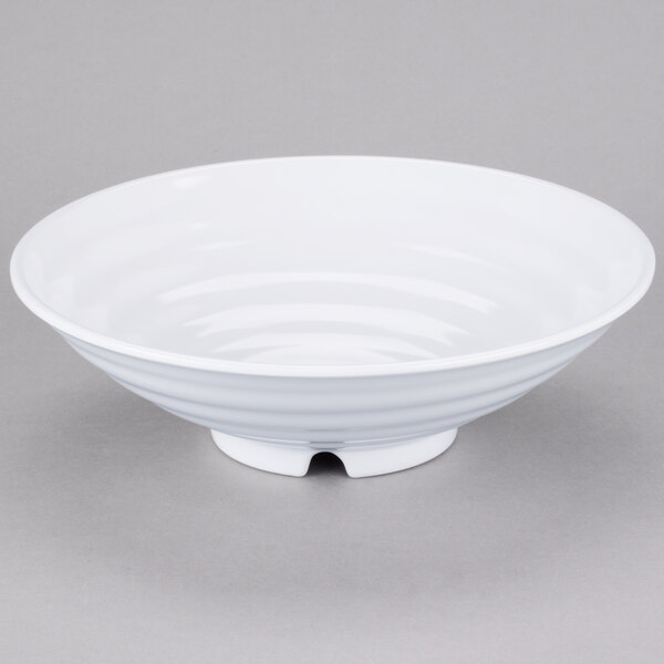 A white GET Milano melamine bowl with a spiral design on a gray surface.