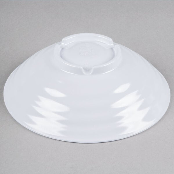 A white Milano melamine bowl with a white rim on a white surface.