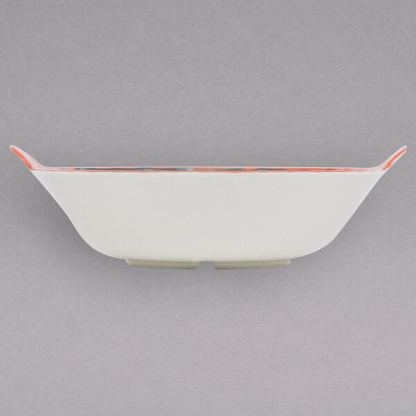 A white bowl with orange trim.
