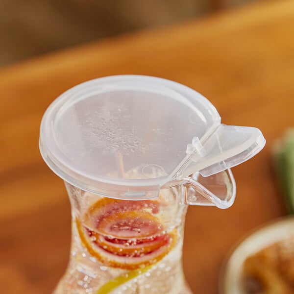 A clear plastic lid on a glass pitcher.