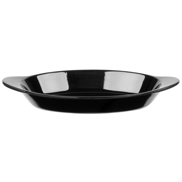 A close up of a black GET oval side dish with a handle.