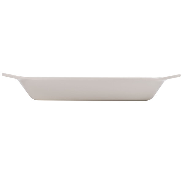 An ivory oval side dish with a handle.