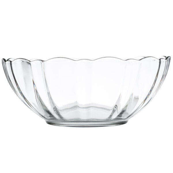 A clear glass bowl with a scalloped edge.