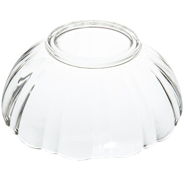 An Arcoroc clear glass bowl with a scalloped edge.