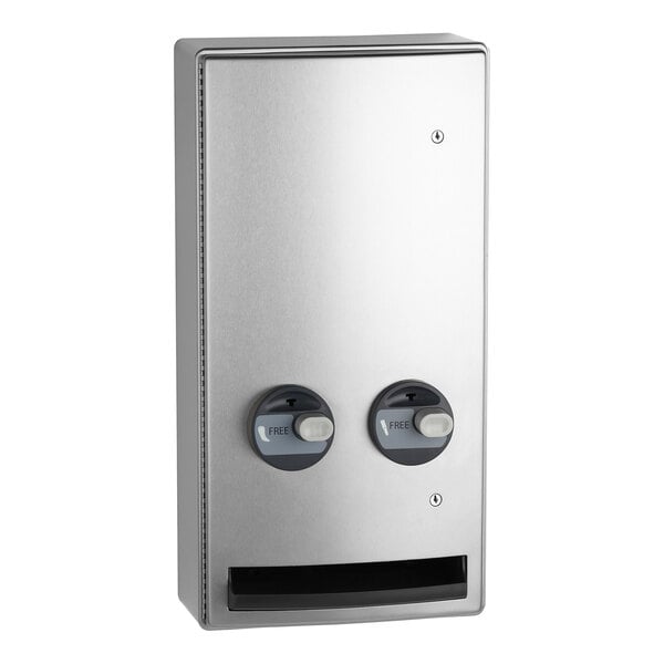 A stainless steel surface-mounted napkin and tampon dispenser with two dispensing knobs and a rectangular product slot at the bottom.