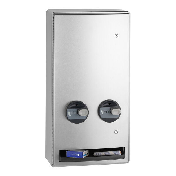 A stainless steel surface-mounted napkin and tampon dispenser with two dispensing knobs and a lower compartment for product retrieval.