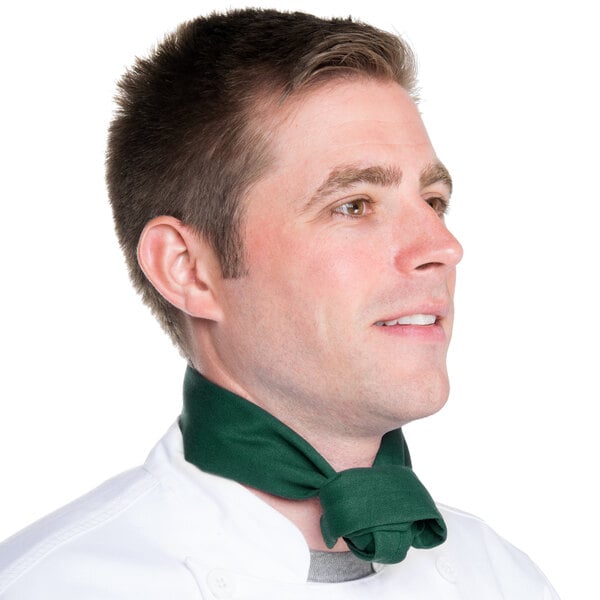 A man in a chef's uniform wearing a hunter green chef neckerchief.