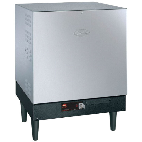 A silver Hatco booster water heater with black legs.