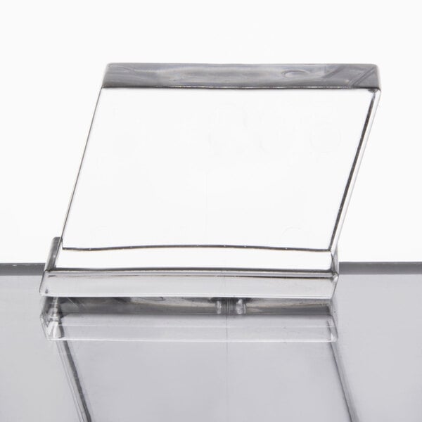 A Manitowoc hotel ice dispenser on a clear glass surface.