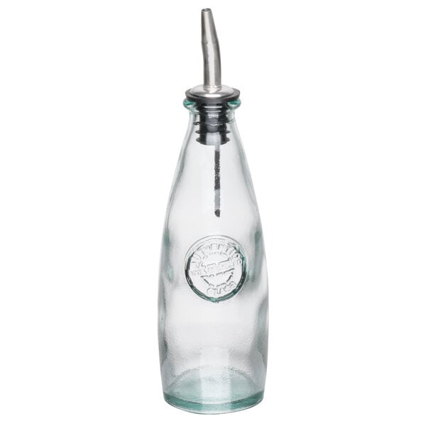A clear glass Tablecraft oil and vinegar dispenser with a stainless steel pourer.