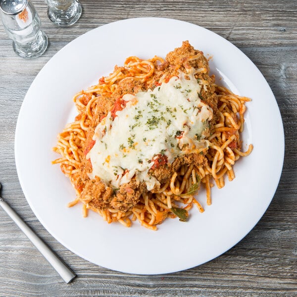 A white GET Diamond White wide rim melamine plate with spaghetti, meat and cheese on it.