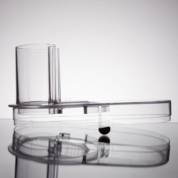 A clear plastic container with a round lid on a surface.