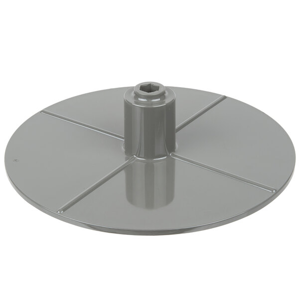 A grey metal Waring slinger disc with a circular hole.