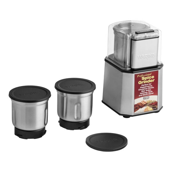 A commercial spice grinder with a stainless steel body, three grinding bowls with lids, and a clear top cover.