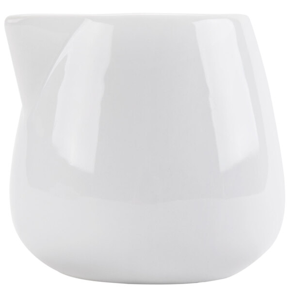 A white ceramic CAC creamer with a curved edge and handle.