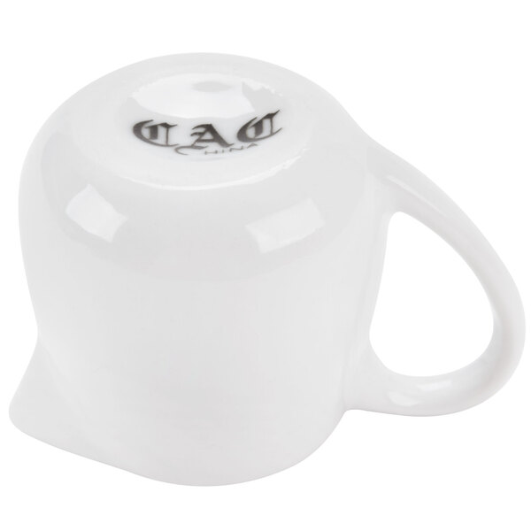 A white porcelain creamer with a handle.