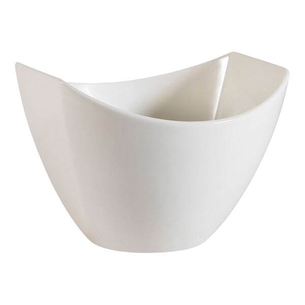 A CAC Studio bone white porcelain salad bowl with a curved edge.