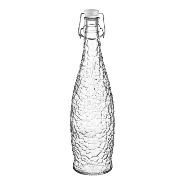 A clear glass Libbey water bottle with a clear wire bail lid.