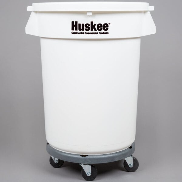 A white plastic Continental trash can, lid, and dolly kit. The trash can says "Huskee."