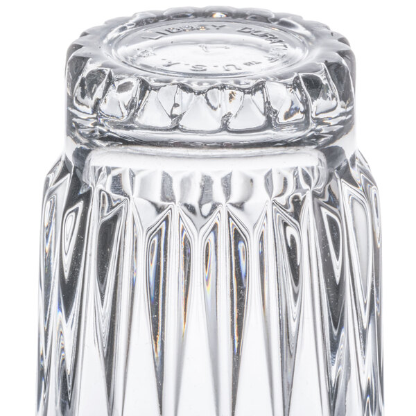 A Libbey Winchester highball glass with a diamond pattern on a table.