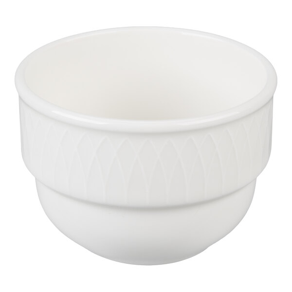A white ceramic bowl with a subtle diamond pattern around the upper exterior and a smooth, rounded base.