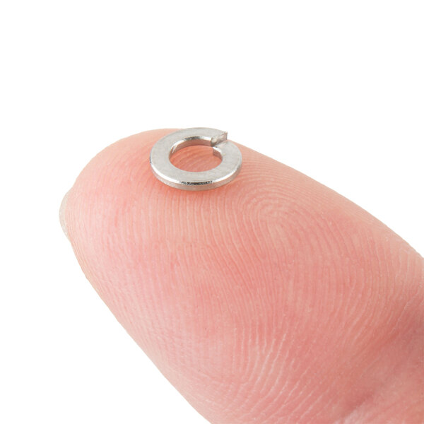 A close-up of a Waring washer on a finger.