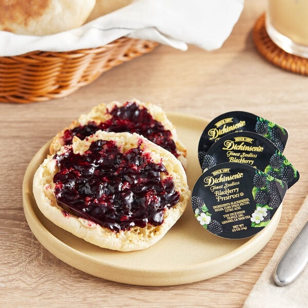 A plate with two muffins, one with Dickinson's Blackberry Preserves on it.