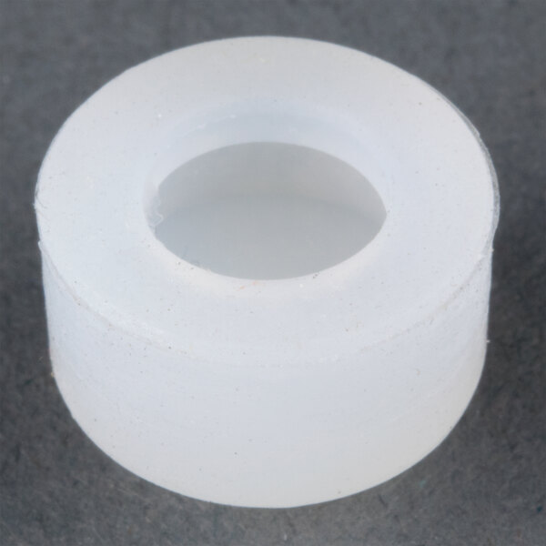 A white plastic ring with a hole.