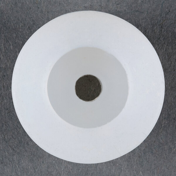 A white circular inner nozzle with a hole in it.
