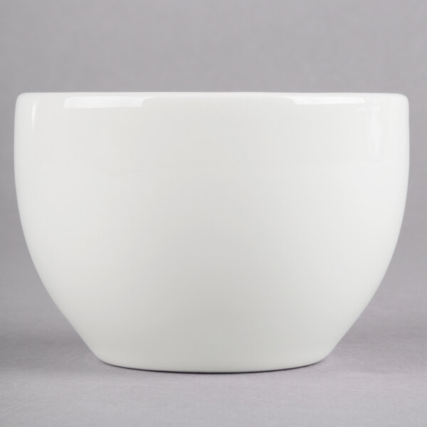 A Homer Laughlin bright white china bouillon bowl with a white rim on a grey surface.