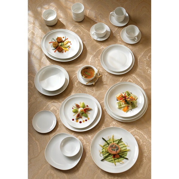 A table with white Homer Laughlin china cups on it.