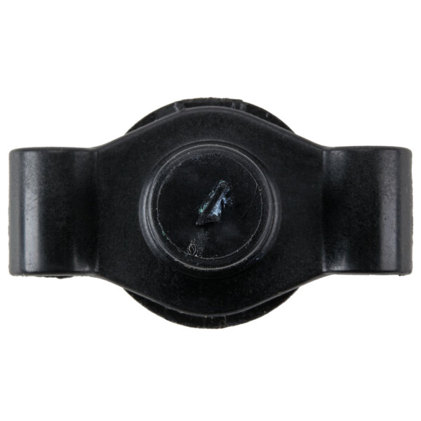 A close-up of a black plastic Waring polishing wheel end cap with a hole in it.