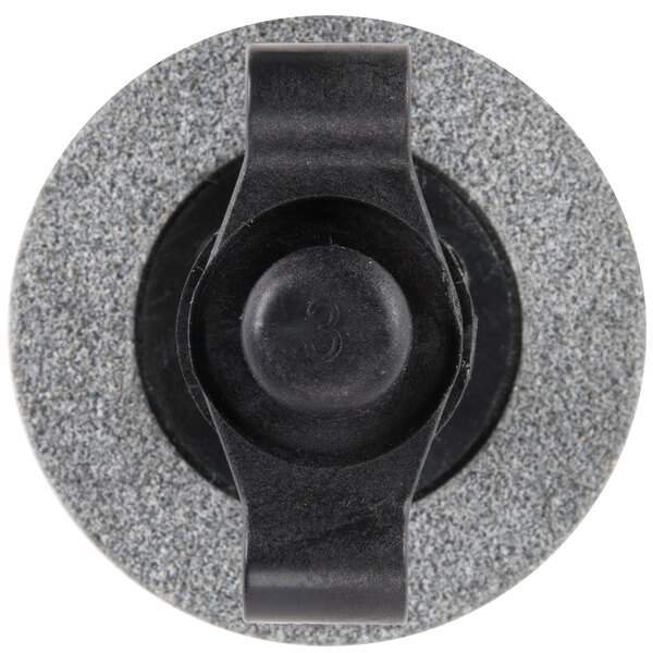 A black and grey circular grinding wheel assembly with a black plastic button.